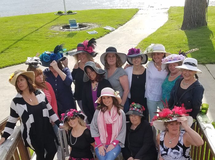 Members in Derby hats on the club lawn