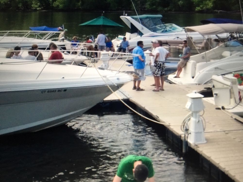 Members on the club dock beside a row of cruisers
